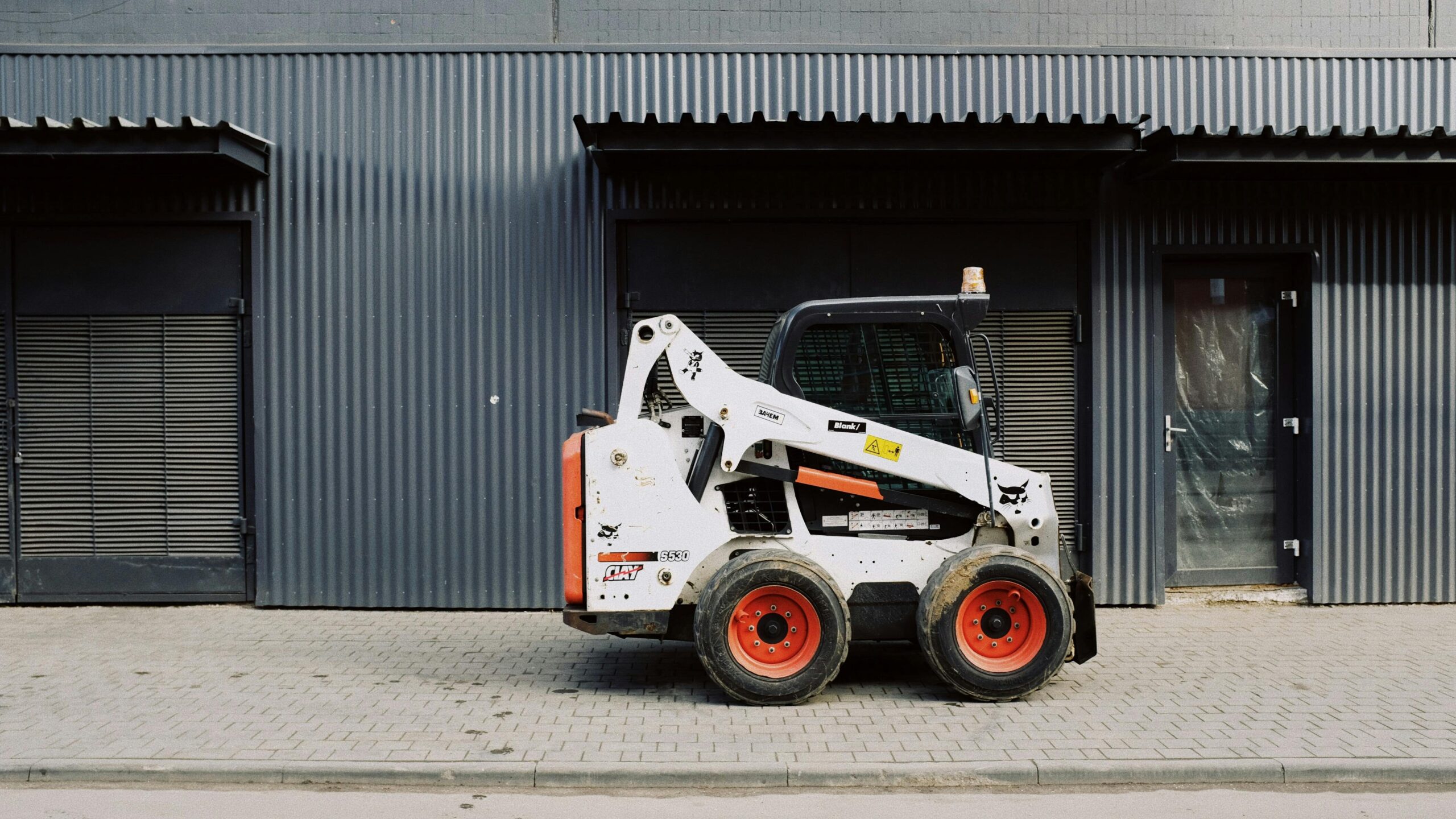 a white and orange vehicle parked in front of a building